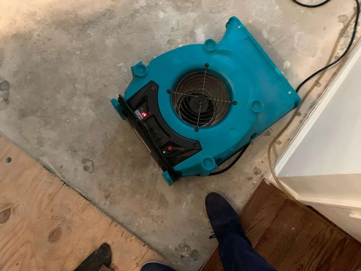 Air mover drying subfloor during Commercial Water Damage Restoration in Glenwood Springs